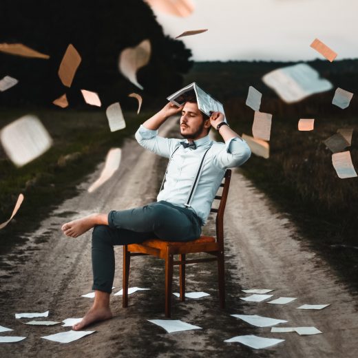 Teen with book pages flying