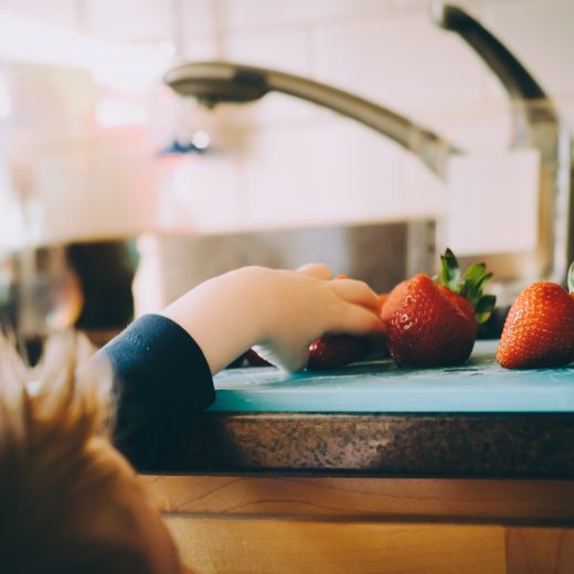 Child grabbing strawberries