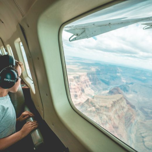 Boy with headphones on plane.